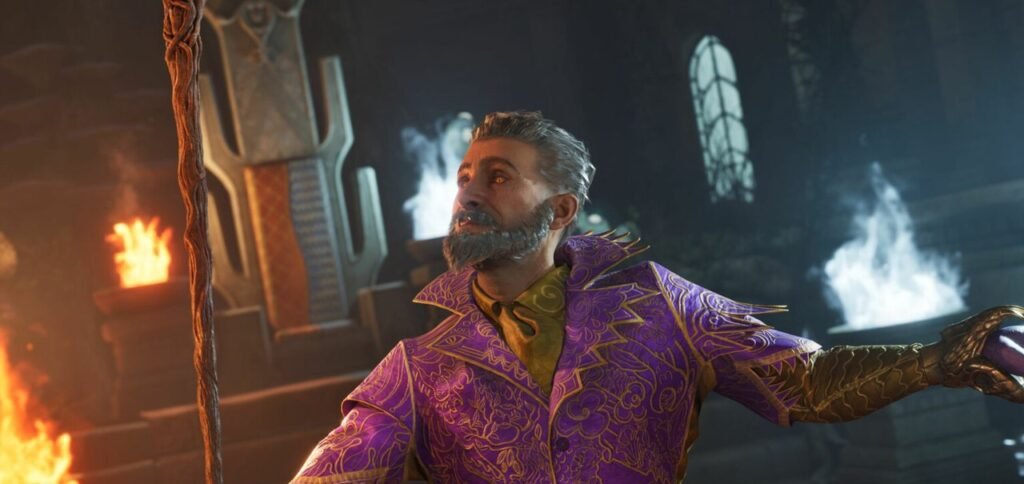 Homem de barba grisalha em traje roxo decorado, segurando um cajado em ambiente místico com chamas e caverna ao fundo.