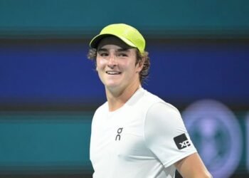 João Fonseca brilha na estreia da chave principal do Madrid Open 35 Tenista sorridente com boné verde e camiseta branca durante partida, em quadra iluminada, transmite energia e confiança.