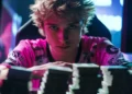 Salários dos jogadores de League of Legends em 2025: desafios e cifras 34 A gamer in a pink jersey leans forward, focused, with stacks of cash on the table